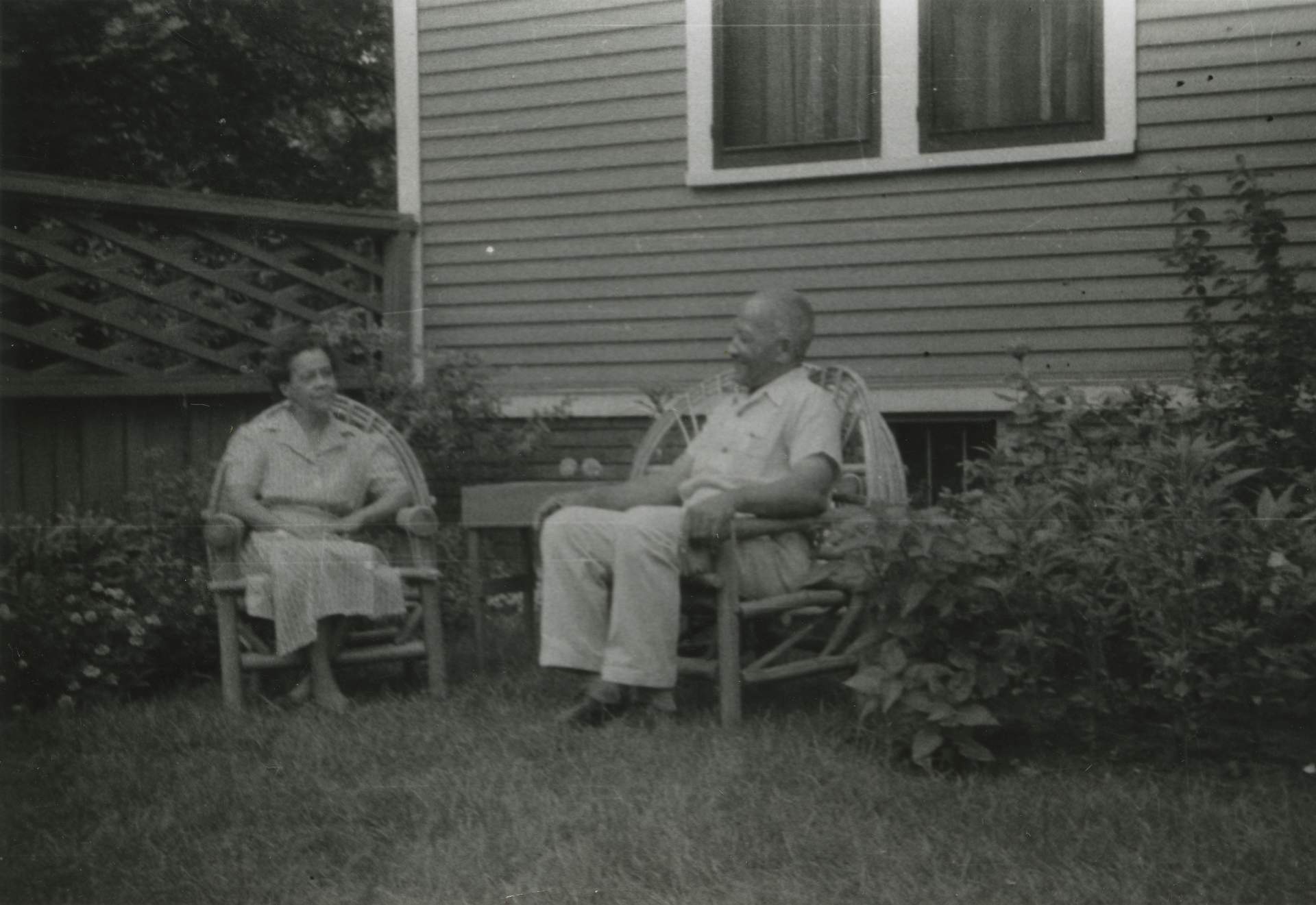 Neeton and John Brent seated in their yard