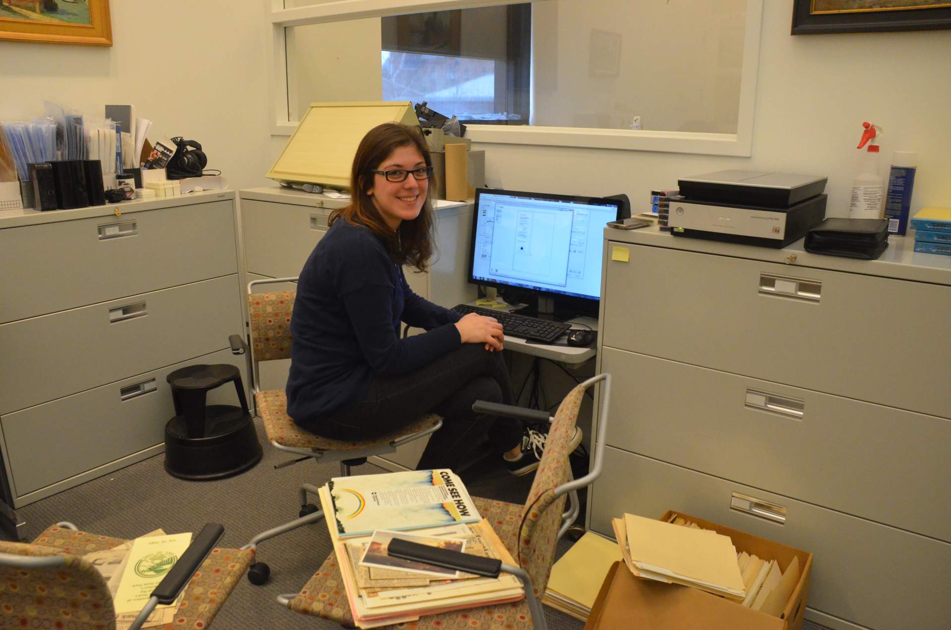 Intern Kirsten Feigel working with and digitizing Past Exhibition Files