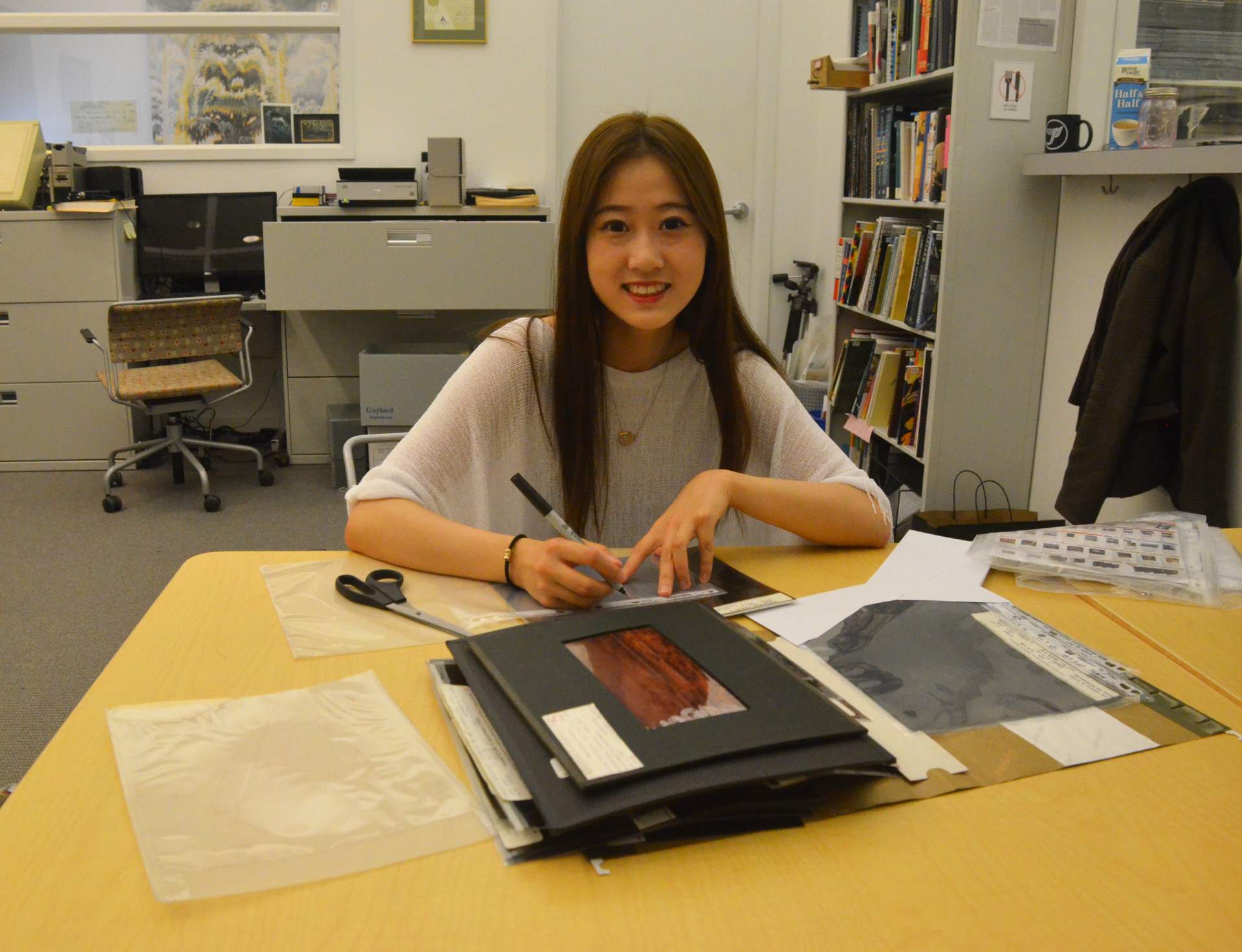Intern Mengyan Tang working with the Charles E. Burchfield Archive