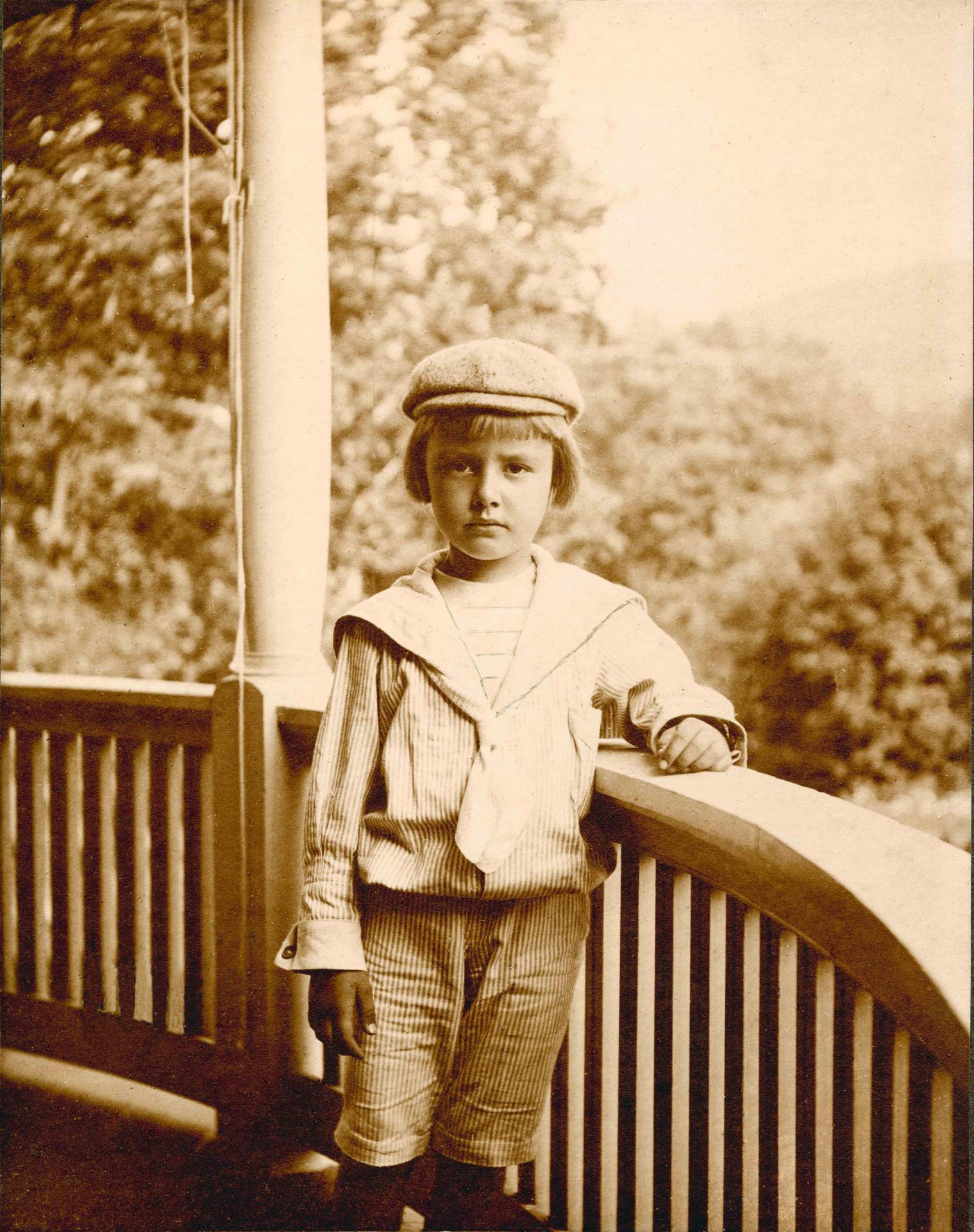 Charles Cary Rumsey, portrait as boy standing on a porch