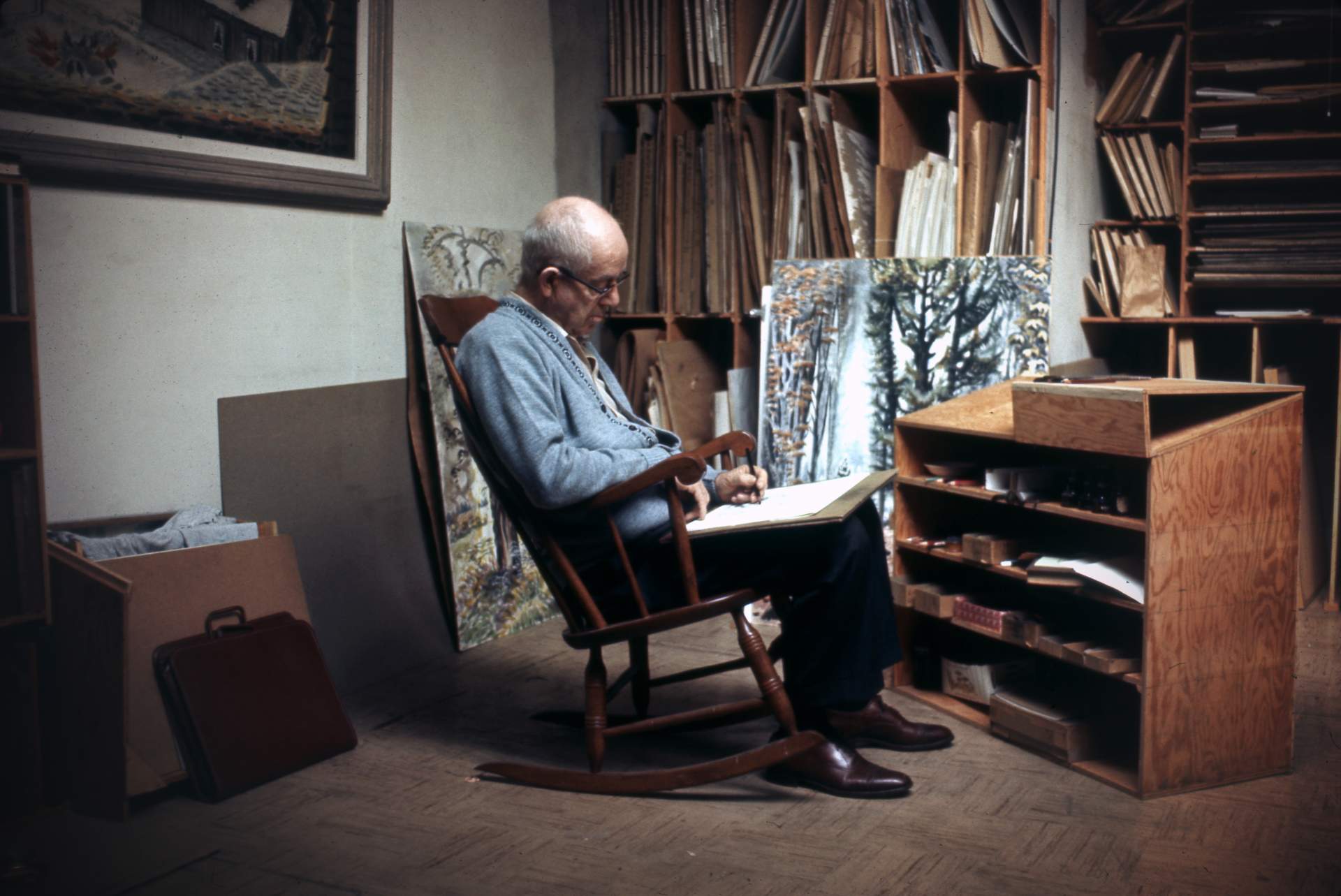 Photograph of Charles E. Burchfield sketching in his studio