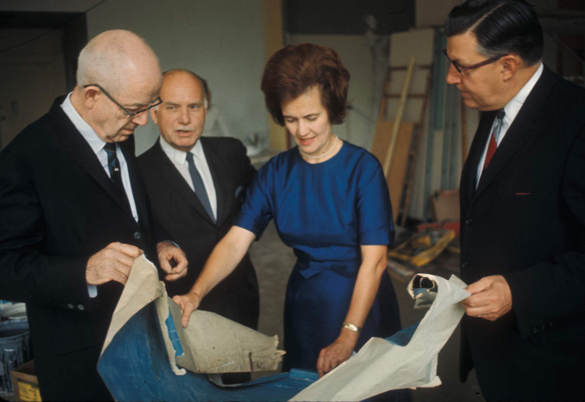 Paul Bulger, Dr. Edna Lindemann, Dr. Kenneth Winebrenner, and Charles E. Burchfield looking at blueprints for the Burchfield Art Center